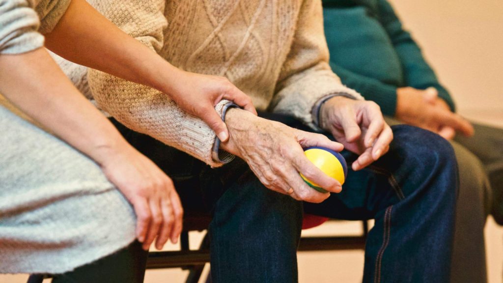Seniors holding hands and holding a ball Seniors holding hands and holding a ball